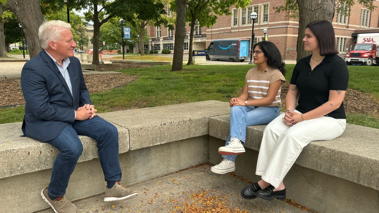 John King talks with Michigan voters Anushka Jalitsagi and Jade Grey in Ann Arbor, Michigan.