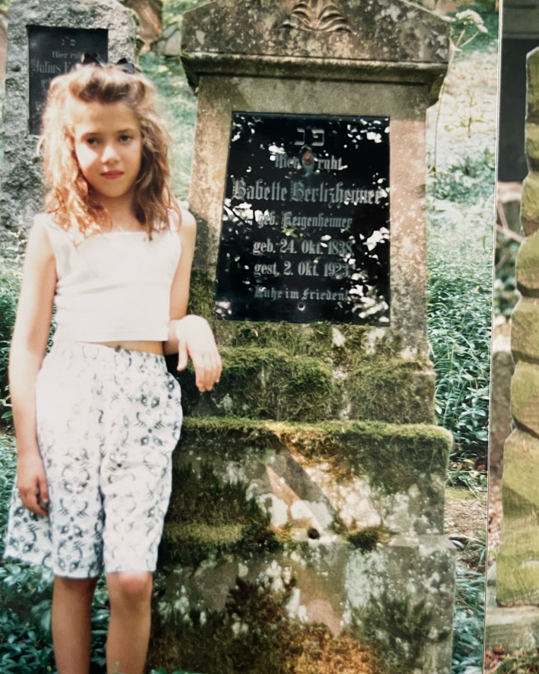 American Erin Levi stands next to the grave of her grandfather's grandmother, Babette Berlizheimer, in Germany during a 1991 visit. Levi now has German citizenship.