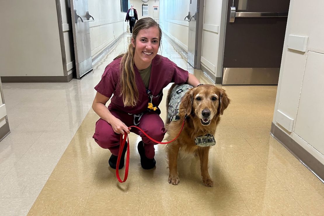 Capt. Molly Murphy with Lt. Cmdr. Ellie Mae, a service dog, at Walter Reed, November 2023.