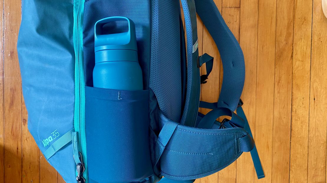 A photo of a blue water bottle in the Cotopaxi Allpa's water bottle holder