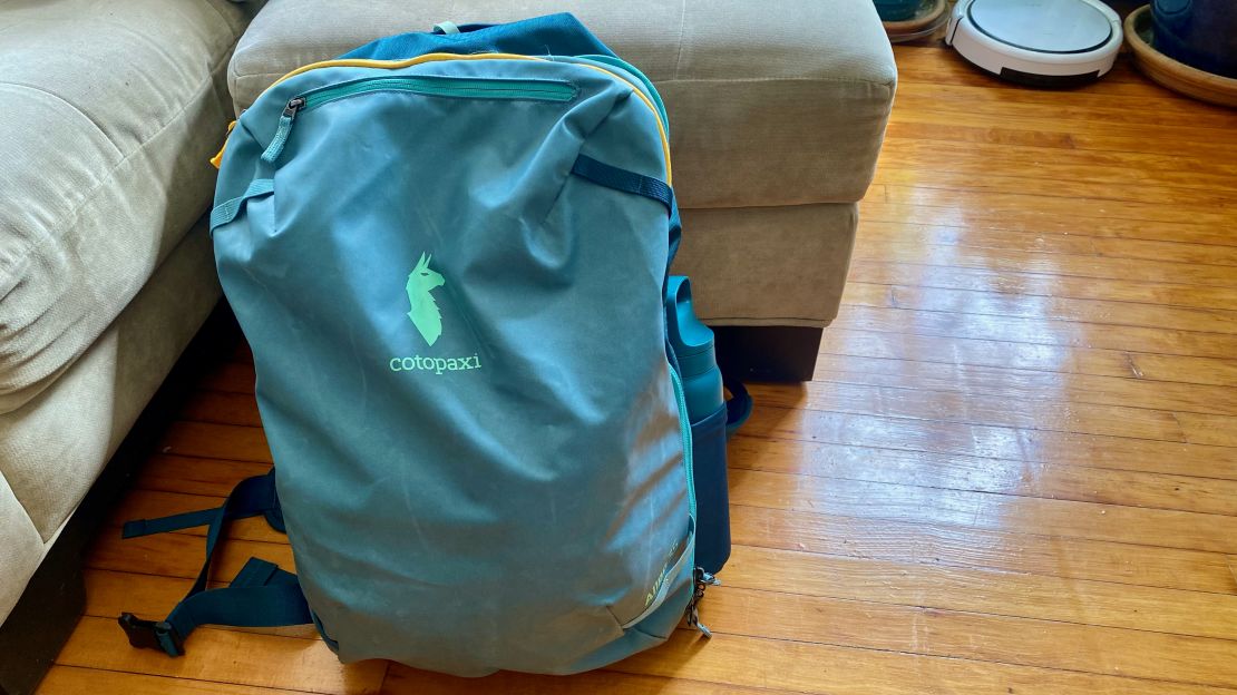 A photo of the front of the Cotopaxi Allpa 35L Travel Pack on a wooden floor