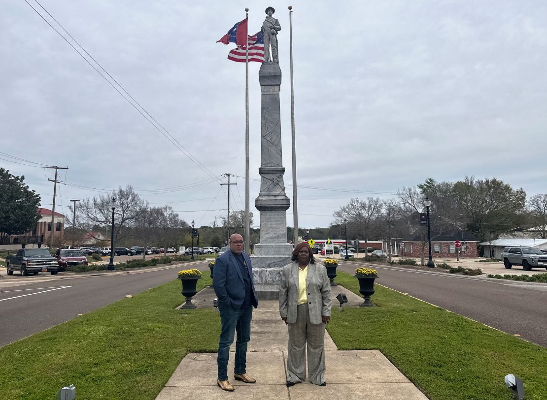 Will Sims, left, and Angela English stand Thursday in front of a Confederate monument in Brandon.