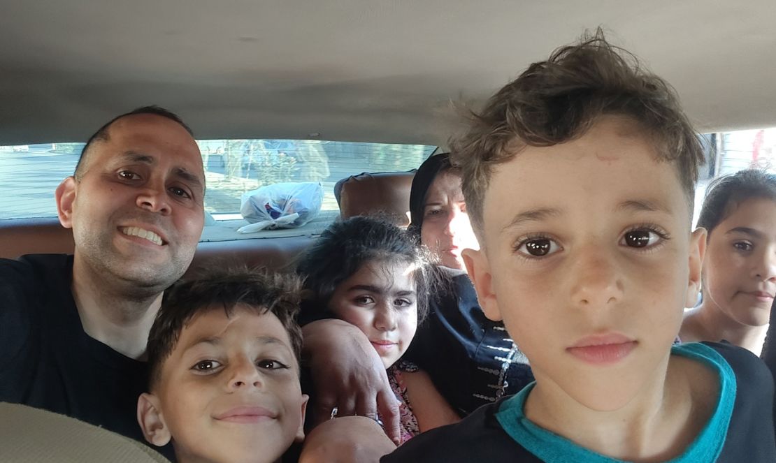 Writer Hani Almadhoun with his family in Gaza, during a visit over summer. His nephews Omar (next to Hani) and Ali (closest to camera) were among those who died in an Israeli airstrike last week.
