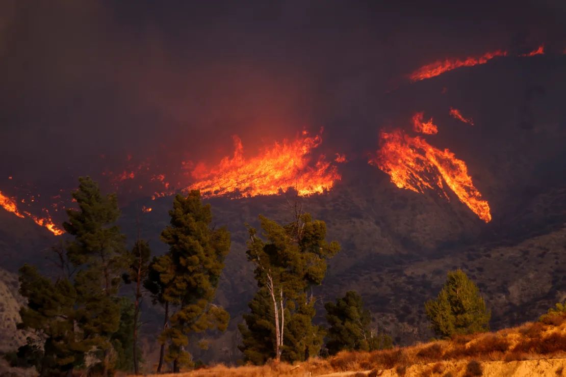 Smoke and flames from the Hughes Fire are seen near Lake Castaic, California, on Wednesday.