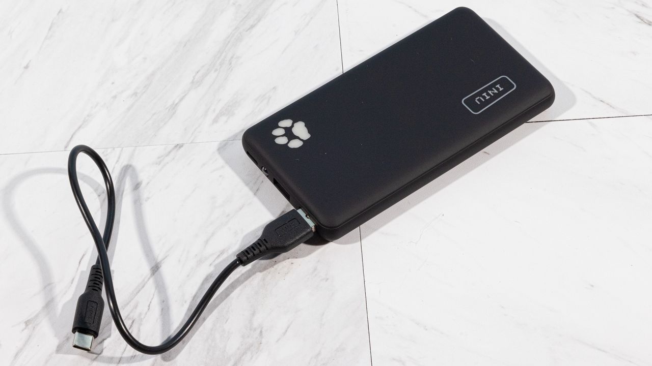 A photo of an INIU power bank with its charging cable attached