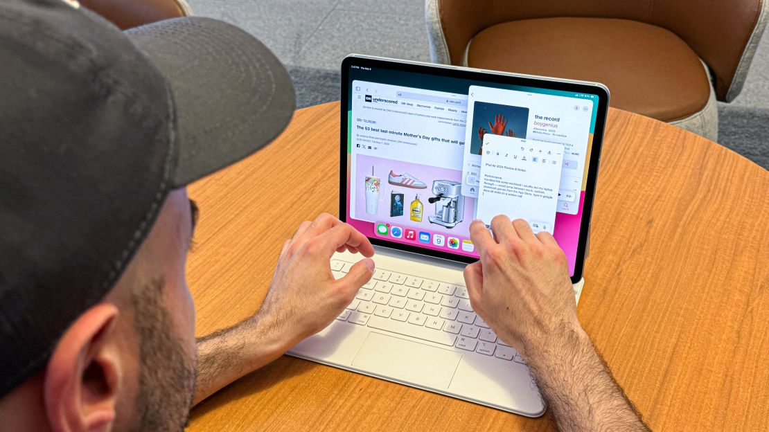 A man is typing on the iPad Air with Magic Keyboard