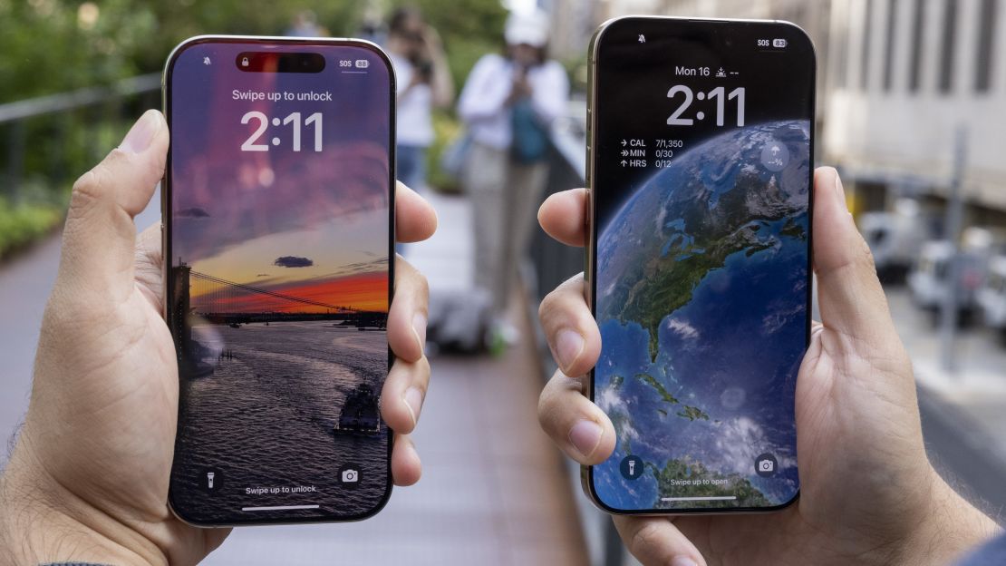 (L, R) iPhone 16 Pro and Pro Max held aloft, open to their lock screens