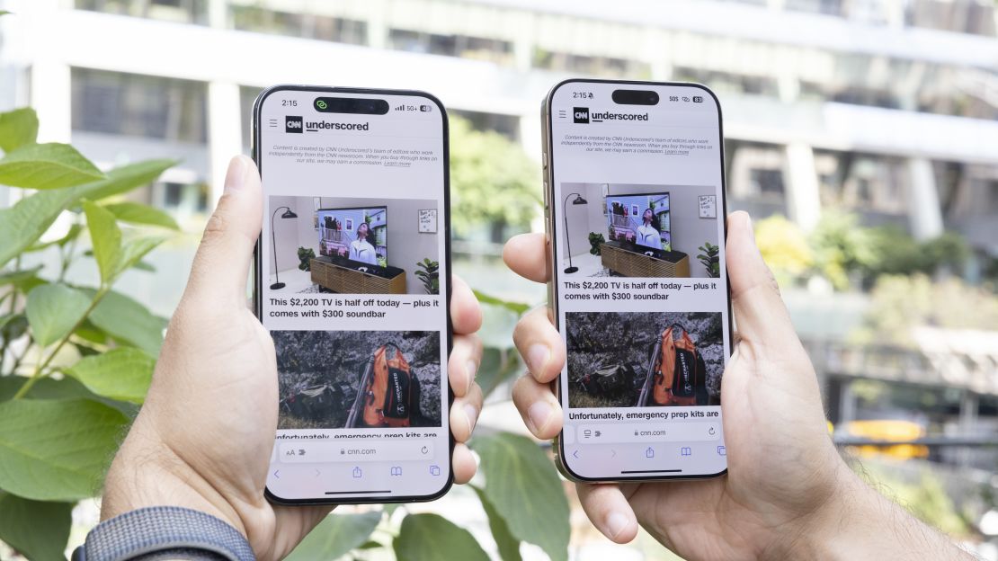 The iPhone 16 Pro (L) and Pro Max (R) are held in the air, with CNN Underscored loaded on their screens