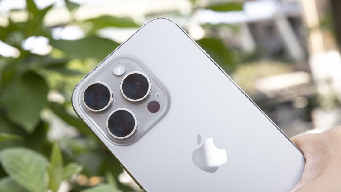 The Natural Titanium iPhone 16 Pro's camera bump is the focus of this shot