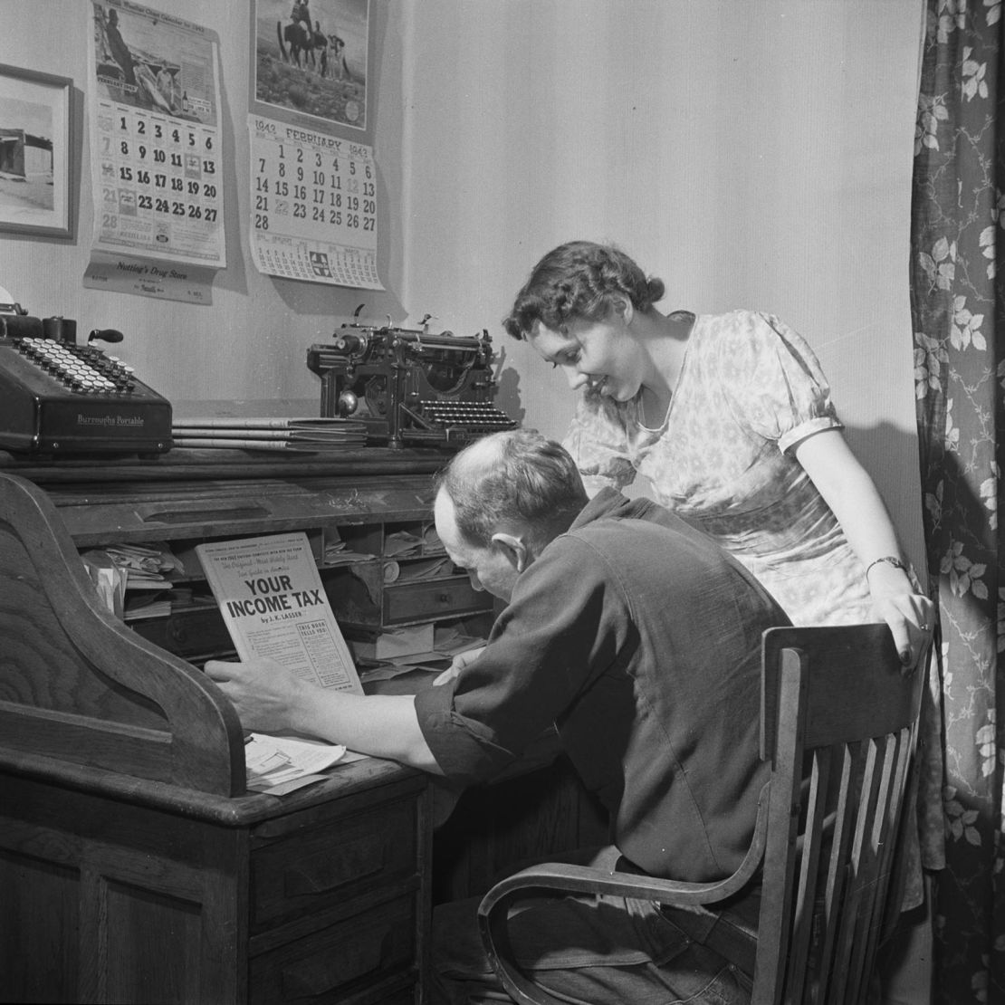 William Heck, a cattleman, and his wife filling out their income tax form in Moreno Valley, New Mexico, in 1943.