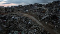 Palestinos caminan entre los escombros de edificios destruidos en Khan Younis, en el sur de Gaza, el 24 de febrero de 2025.