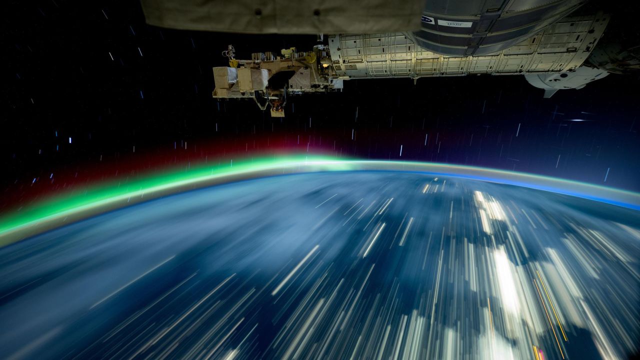 iss072e097446 (Oct. 24, 2024) -- As the International Space Station soared 257 miles above Lake Michigan, NASA astronaut and Expedition 72 Flight Engineer Don Pettit captured this long-exposure photograph of city lights streaking across Earth while a green and red aurora moved through the atmosphere. 
