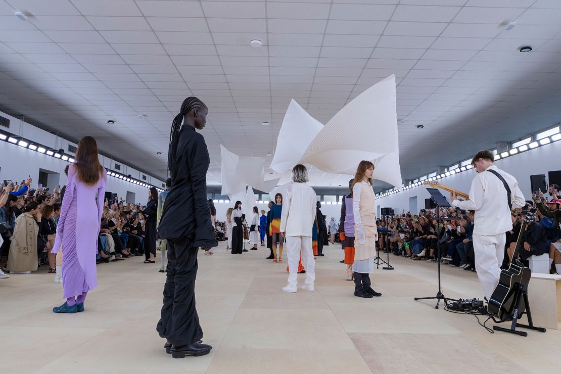 Live music and an installation of pleated pieces of washi paper, designed to float freely in the air, served as an engaging, multi-sensory backdrop for the Issey Miyake show.