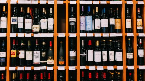 A photo of wine bottles on a shelf at a liquor store in Spain