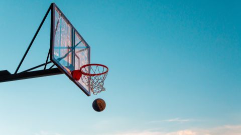 A photo of a basketball hoop against a blue sky