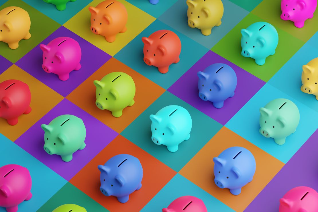 A photo of piggy banks in multiple colors on a multi-colored checkered background