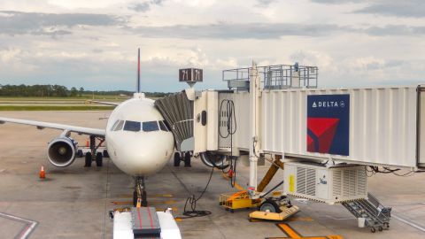 A photo of a Delta Air Lines jet parked at the gate in Orlando