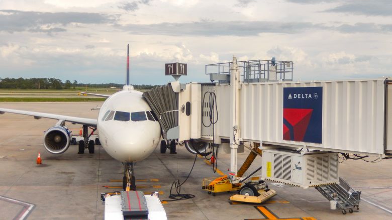A photo of a Delta Air Lines jet parked at the gate in Orlando