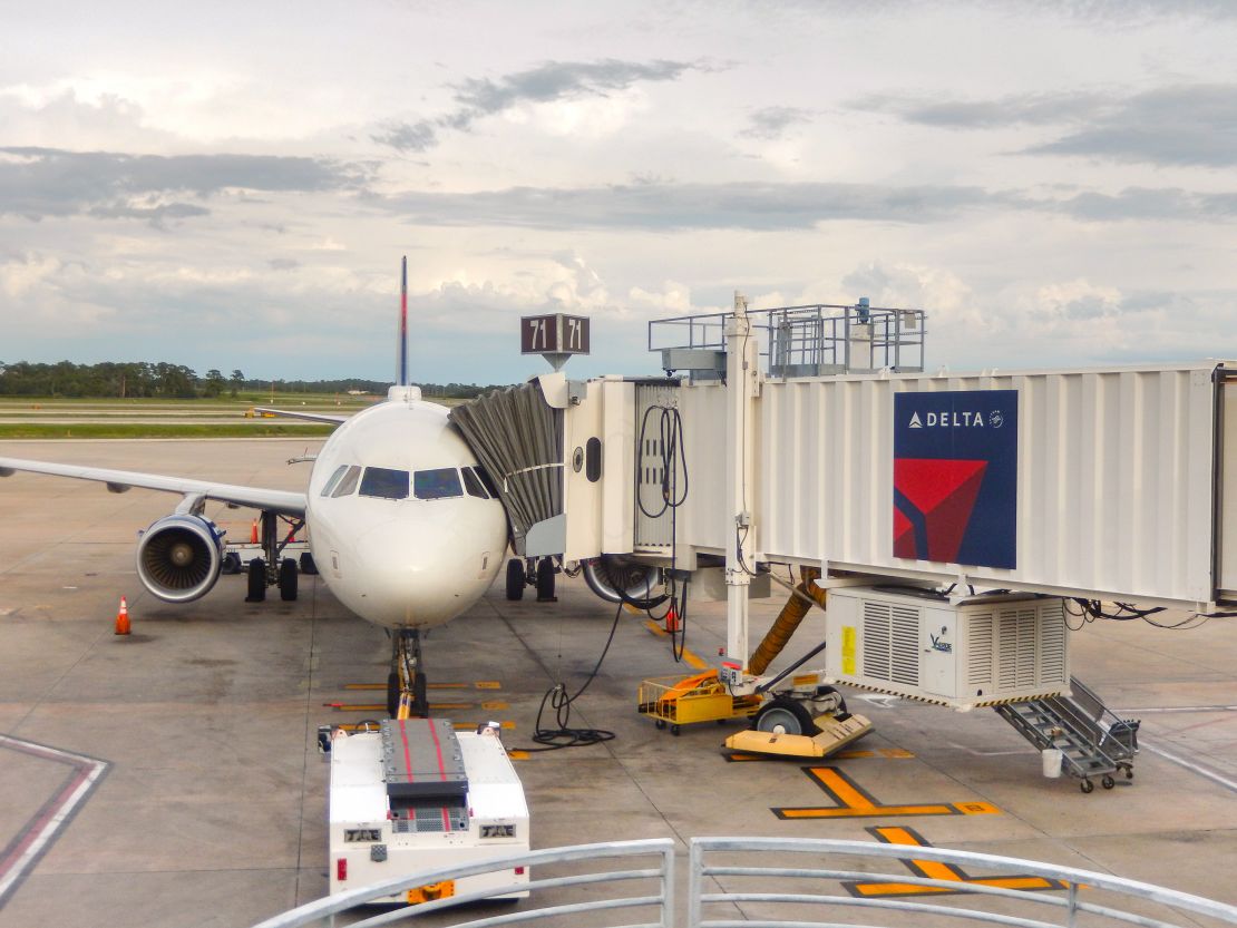 A photo of a Delta Air Lines jet parked at the gate in Orlando