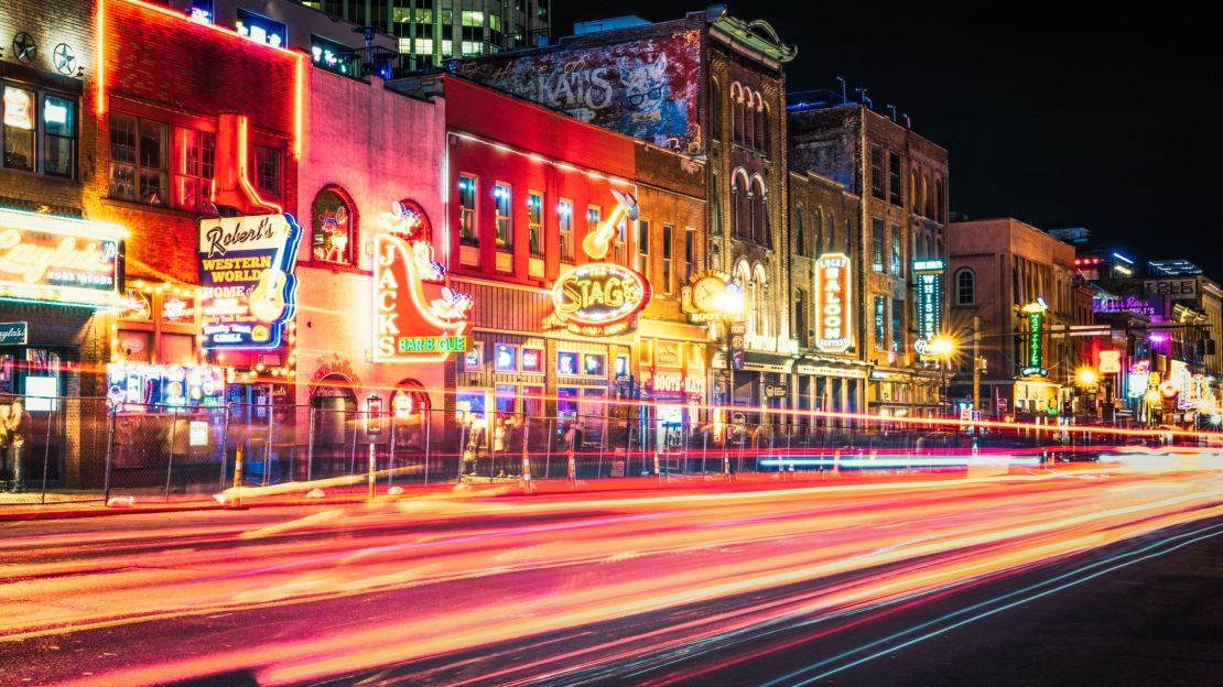 A photo of cars driving on Nashville's Lower Broadway street