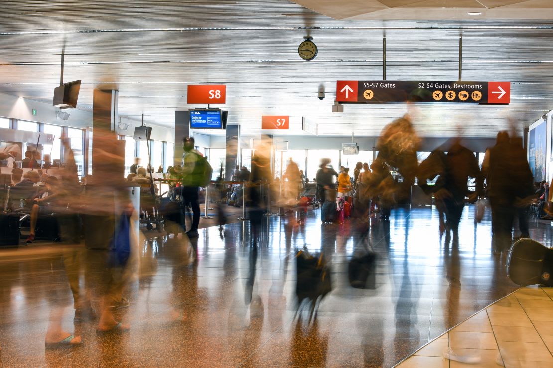 A photo of passengers passing through a busy terminal at Seattle-Tacoma International Airport (SEA)
