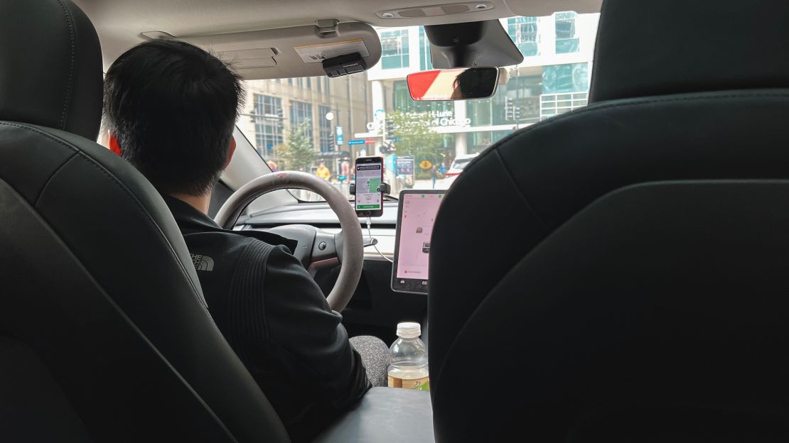 A photo of a person driving a Tesla in Chicago, Illinois