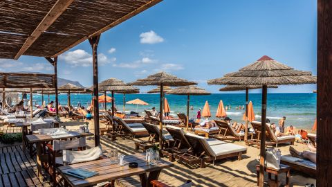 A photo of beach chairs and umbrellas on the beach in Crete, Greece