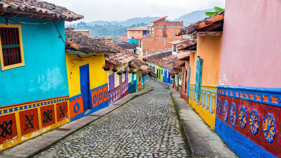 A photo of colorful colonial houses on a cobblestone street in Guatape, Antioquia in Colombia.