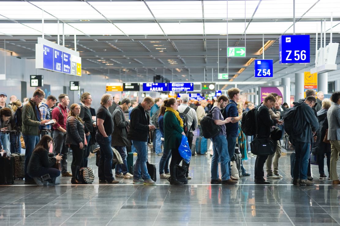 A photo of a long line of passengers waiting to board a flight in Frankfurt Airport (FRA)