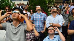 A photo of people viewing a solar eclipse in Manhattan's Bryant Park in 2017