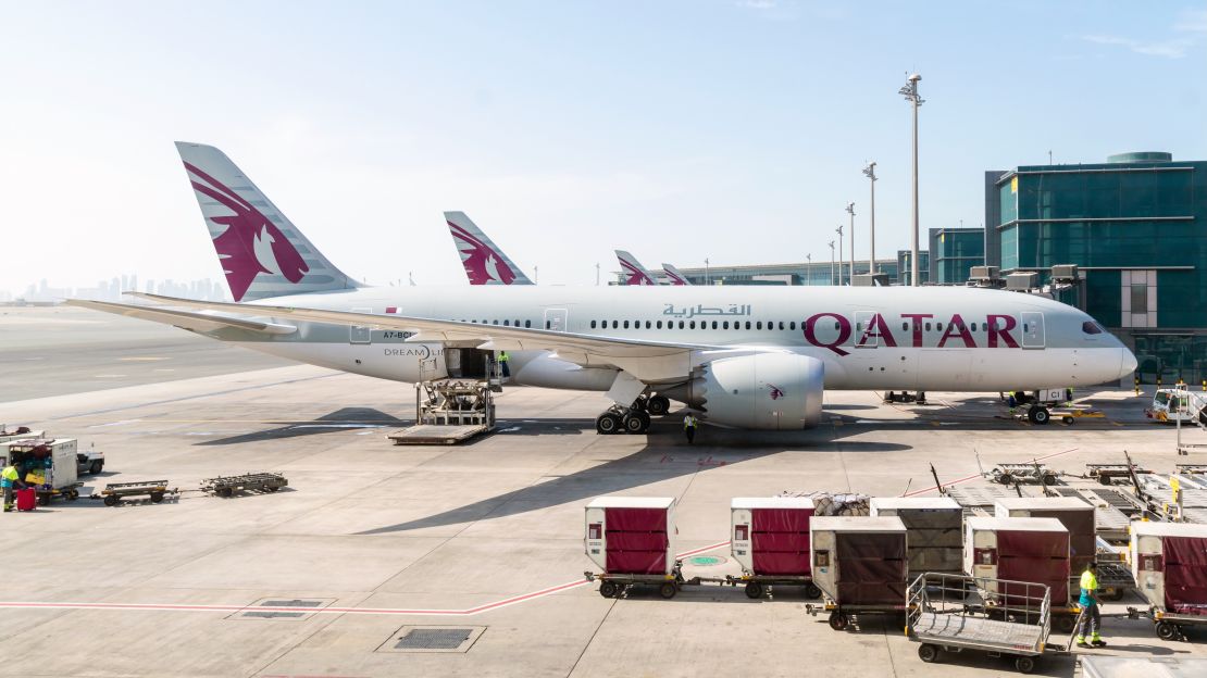 A photo of a Qatar Airways Boeing 787 parked at an airport gate