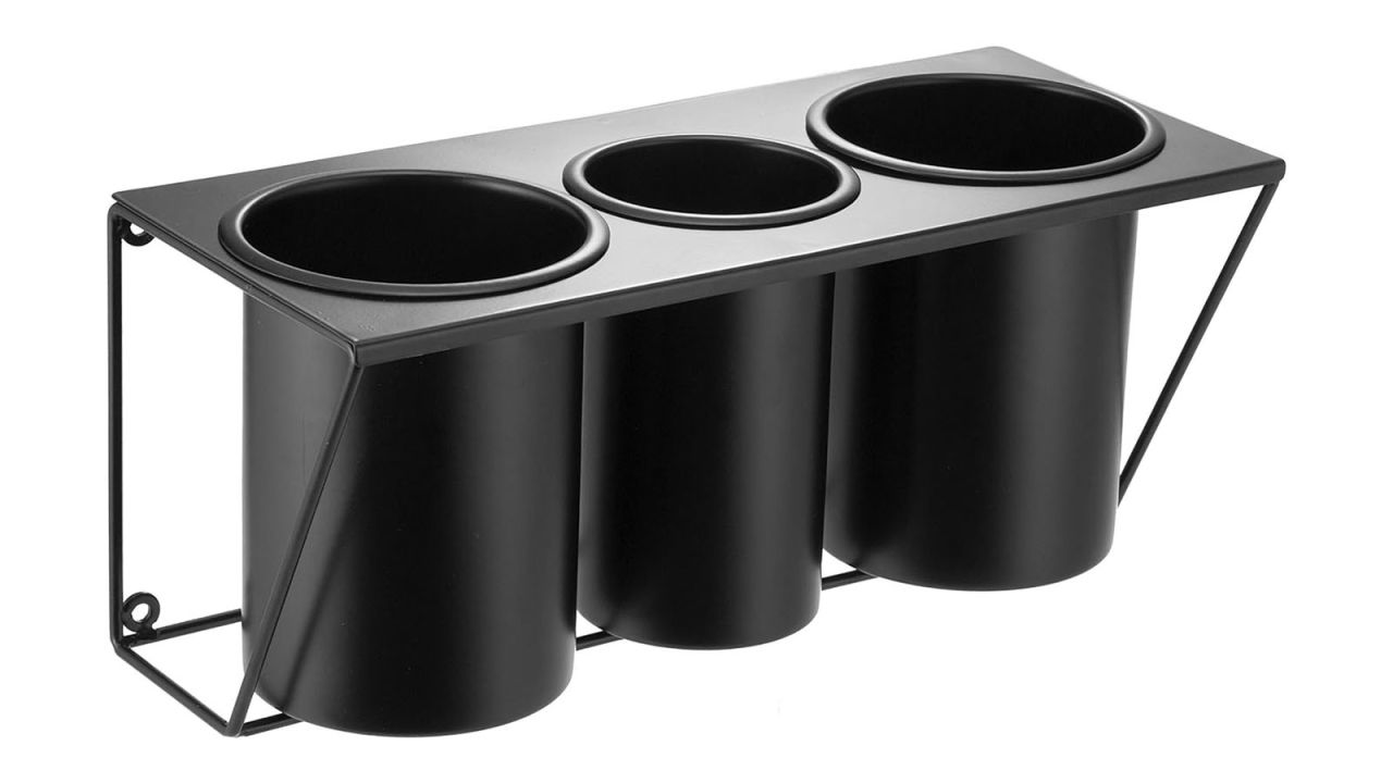 An empty hair tool organizer consisting of three cylindrical bins fit into a mountable frame.