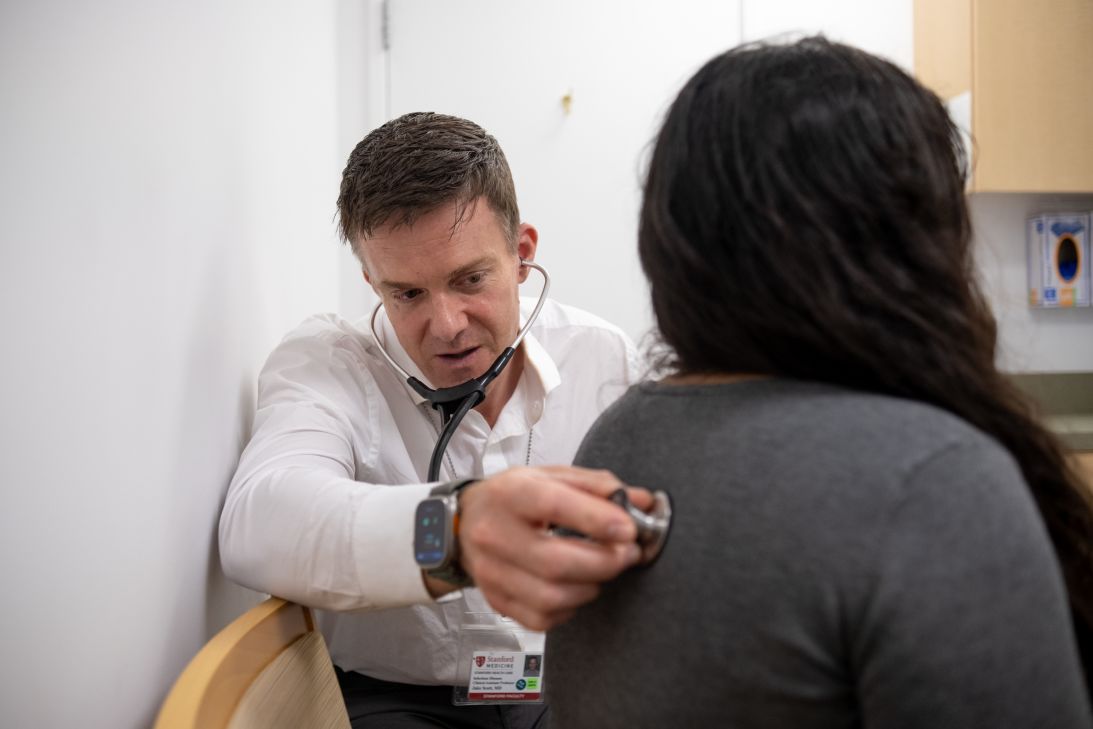 Dr. Jake Scott listens to a patient’s heartbeat during an appointment at Stanford Health Care Infectious Diseases Clinic in Pleasanton, California, on August 12.