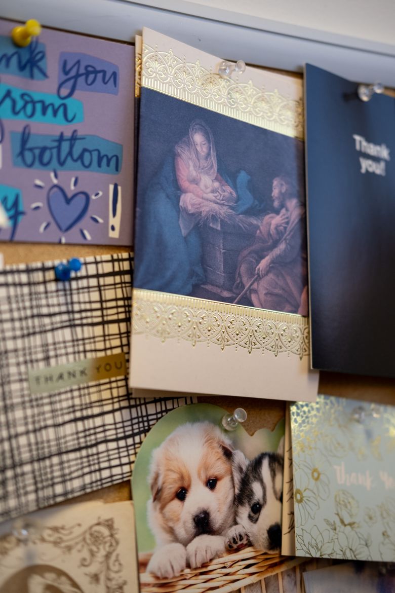 Thank you notes — including one in the center from his work in the hospital during the Covid-19 pandemic — decorate a cork board in Dr. Jake Scott’s office at Stanford Health Care Infectious Diseases Clinic.