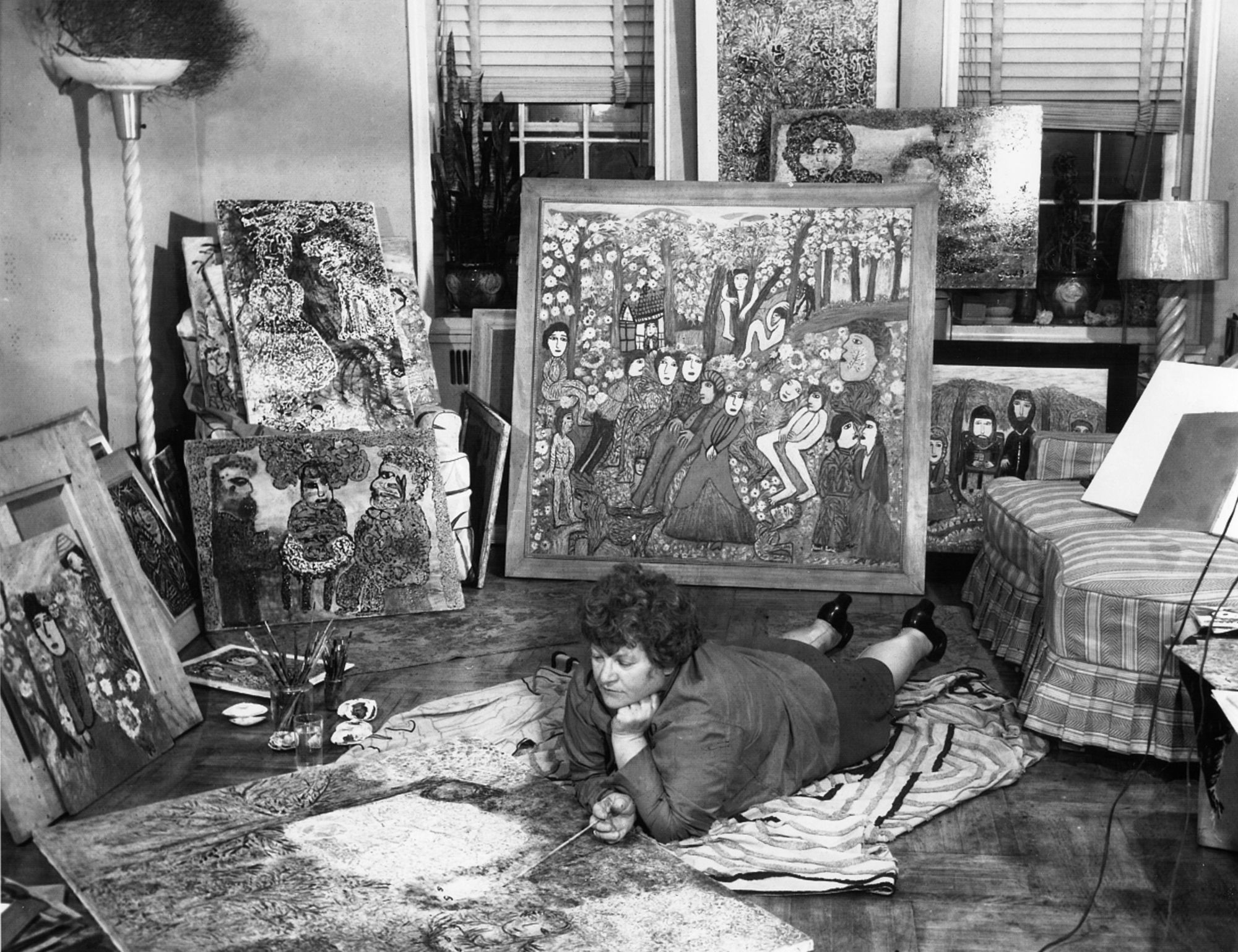 The artist Janet Sobel, pictured painting on the floor of her apartment in Brooklyn, circa 1944.