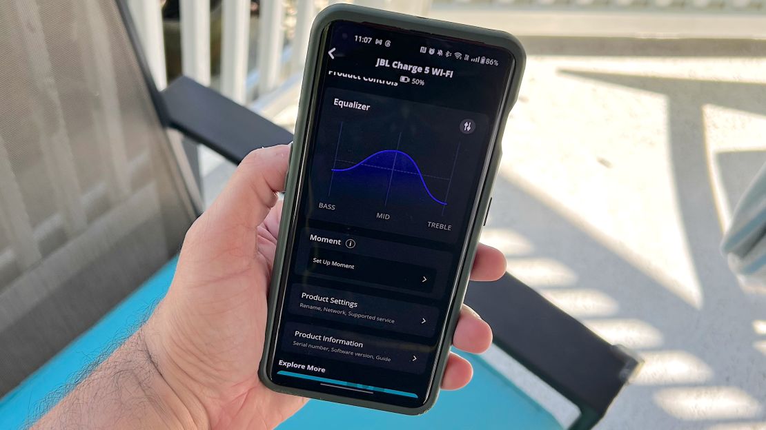A phone displays the JBL One app on its screen.