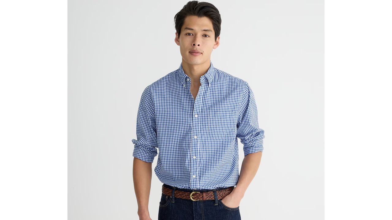 Man wearing blue gingham secret wash cotton poplin shirt fro J.Crew