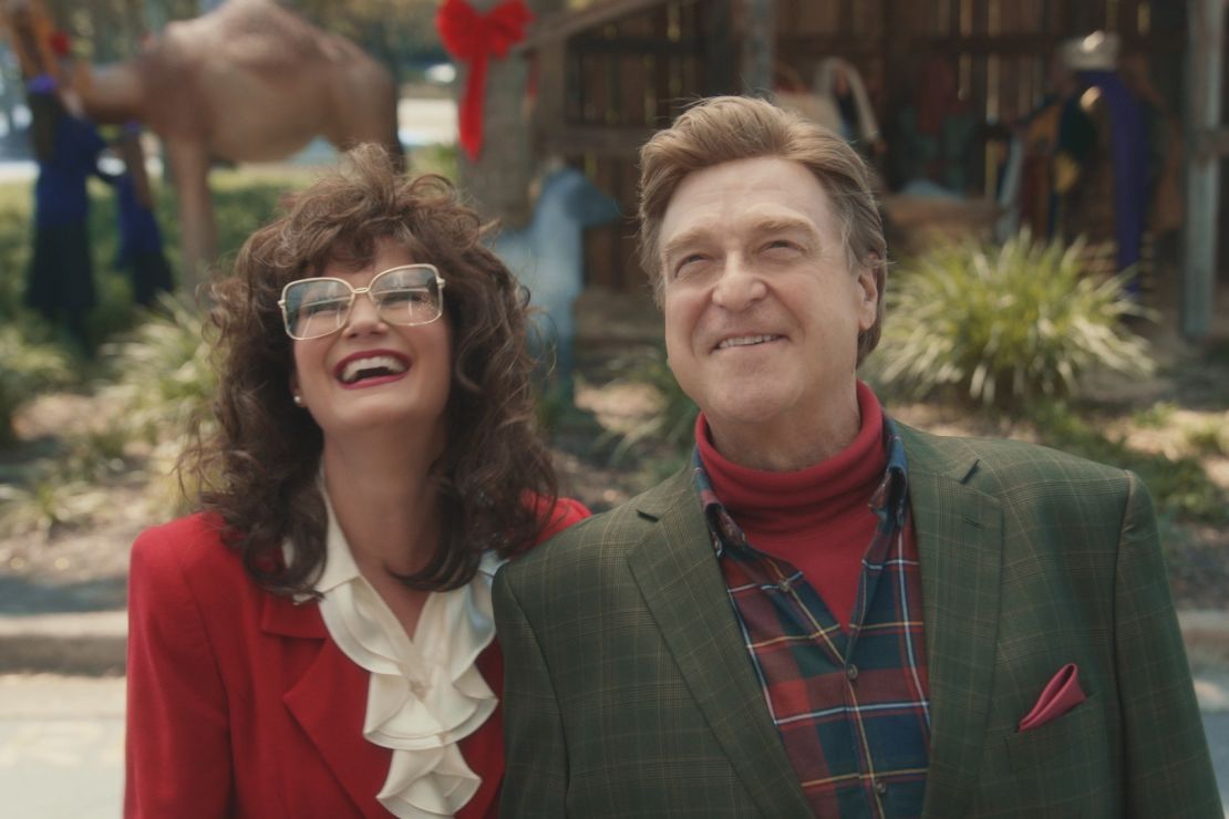 Aimee Lee (Jennifer Nettles) and Eli (John Goodman) share style similarities — namely big hair and coordinating looks — with real-life '80s televangelists.