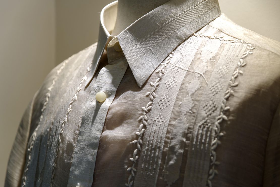 A close-up shot of the barong highlights the shirt's intricate embroidery and fabrication.