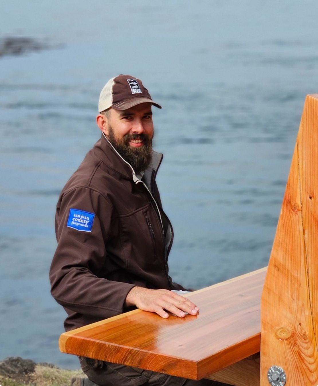 Joe Ingman installing a bench he built at Shark Reef County Park in September 2023. Ingman, a park manager in the county, said the 32-hour workweek made his job easier by attracting a better applicant pool.