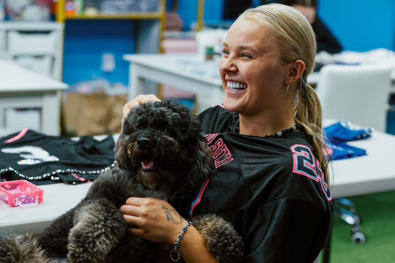 Siwa snuggles with her poodle, Clyde.