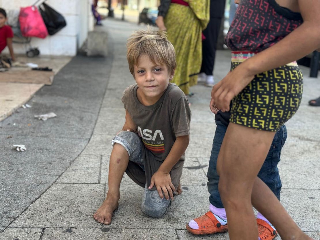 A young barefoot boy among the displaced on the sidewalks of central Beirut.