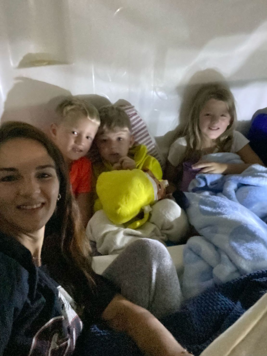 Kristin Jones took a selfie to send to her husband of her with her sons Cooper and Witten, 6, her daughter Sienna, 9 and the family dog hunkered down in the bathtub as Hurricane Helene knocked trees into their home.