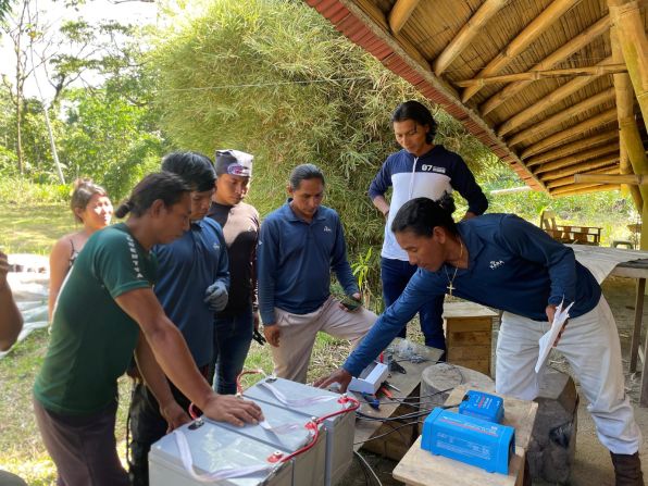 Kara Solar technicians pictured near Puyo, Ecuador, preparing equipment for an installation.