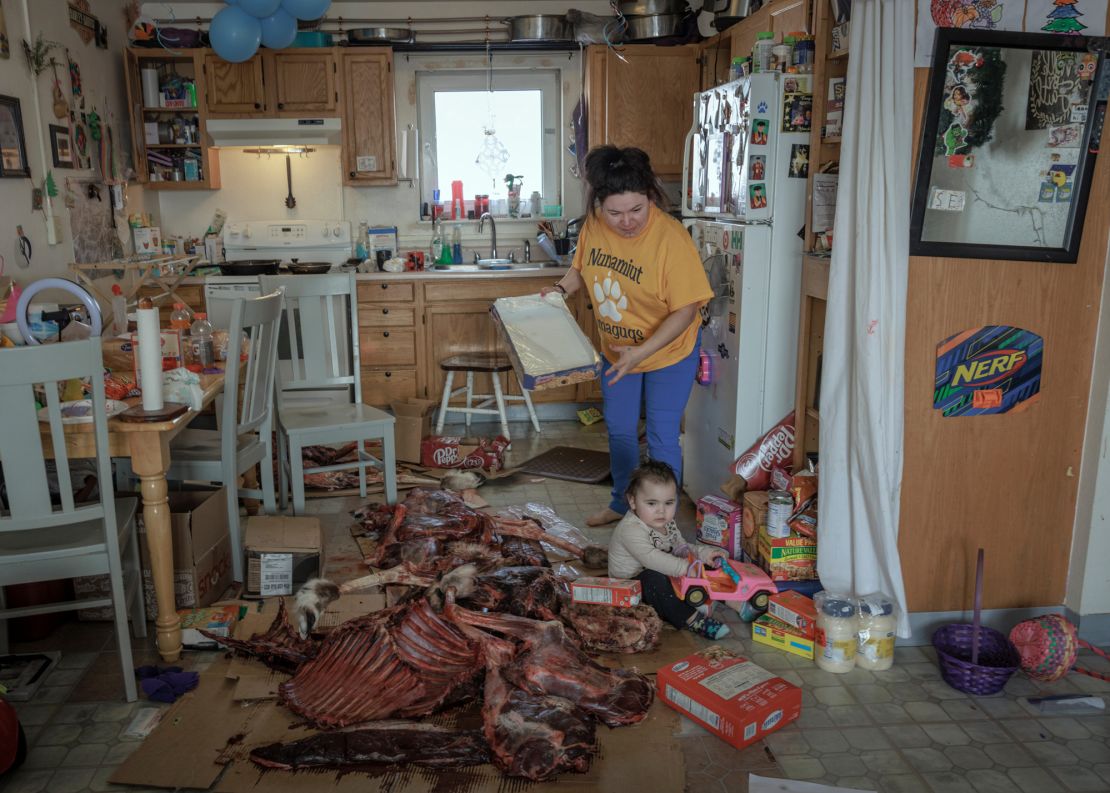 Katie Orlinksy's image of a woman processing a caribou in Alaska's Anaktuvuk Pass.