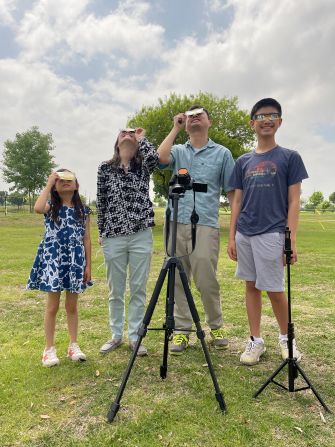 Sandy Jung-Wu (second from left) of Los Angeles viewed the eclipse in McKinney, Texas, with her husband, Bob J. Wu, and kids Kayleigh (far left) and Cayden. Despite a looming storm, "the clouds all seemed to dissipate within minutes of totality," Jung-Wu said.