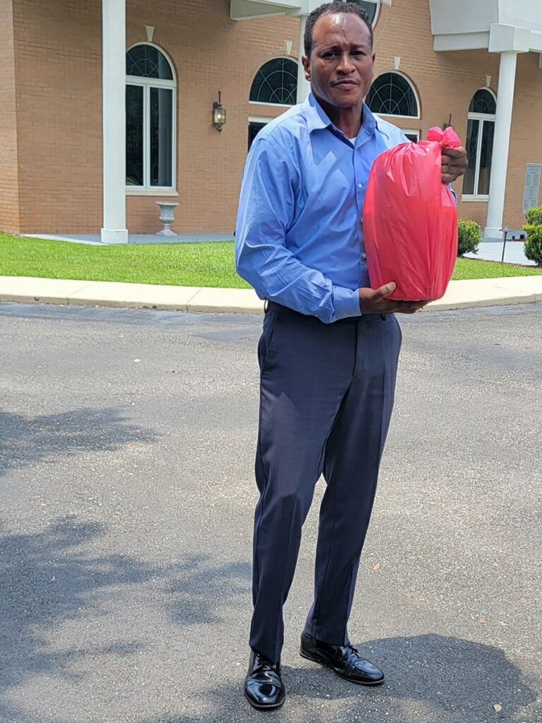 Simone De Moore holds a bag of Kelvin Moore's organs after retrieving them from UAB,