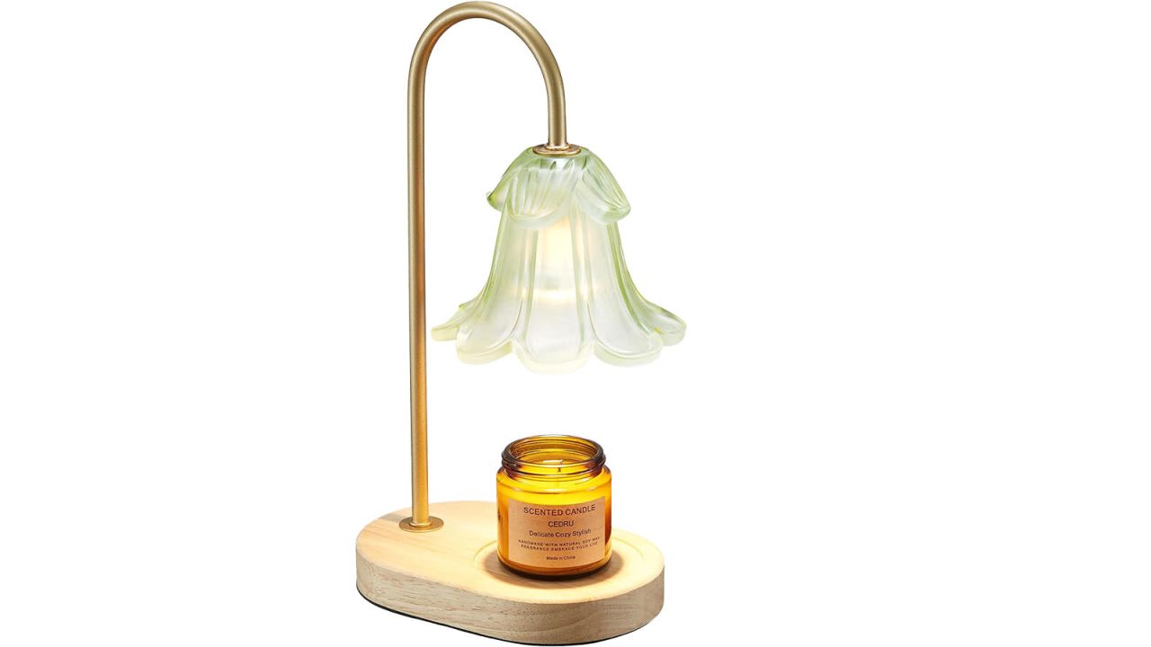 Candle warmer lamp with glass, flower shaped lampshade holding small candle at the base.