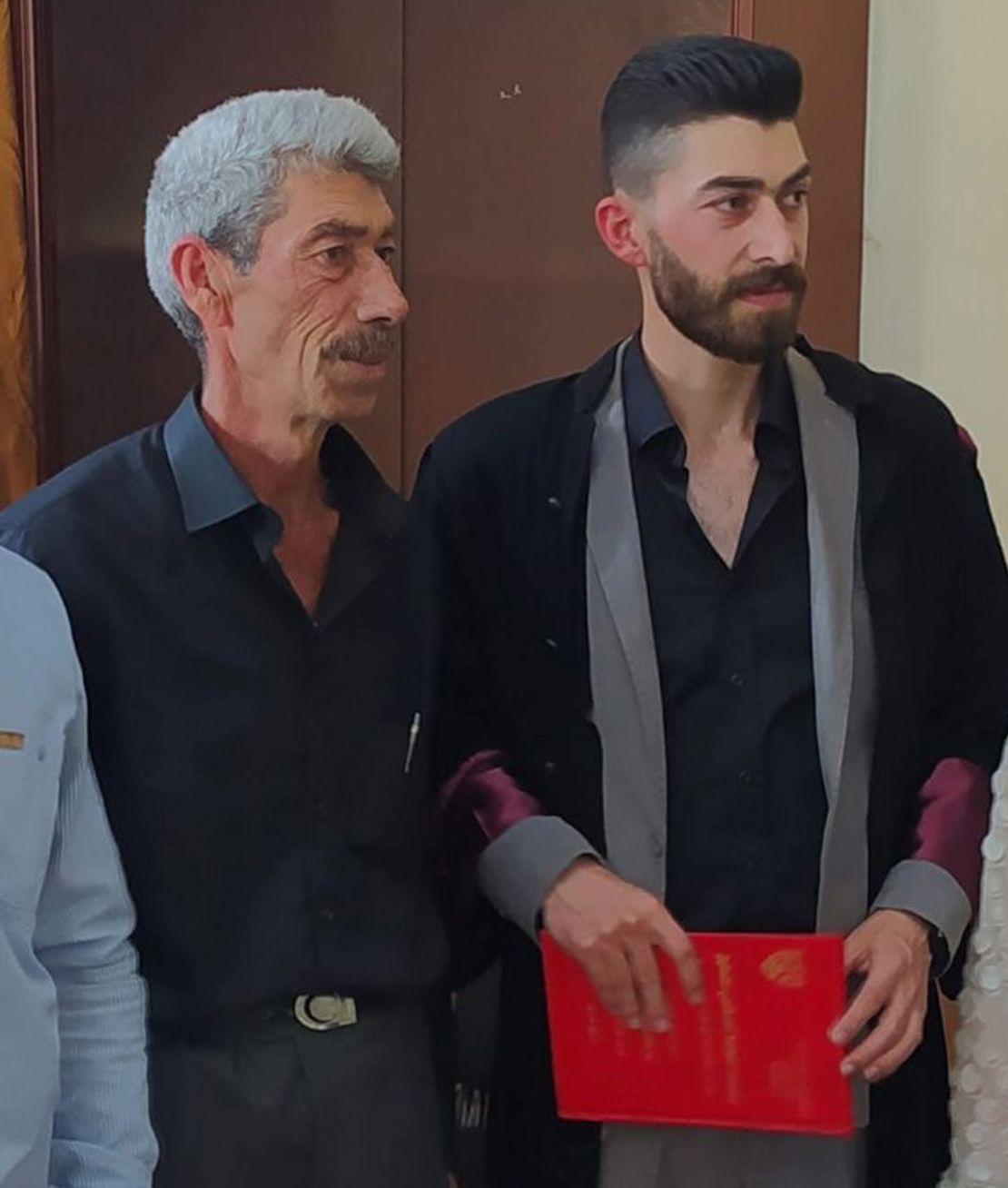 Mohamed Khalil, left, is pictured with his son Zain. They were gunned down on March 7. Their bodies appear at the feet of the fighter who filmed himself as he ransacked their home.