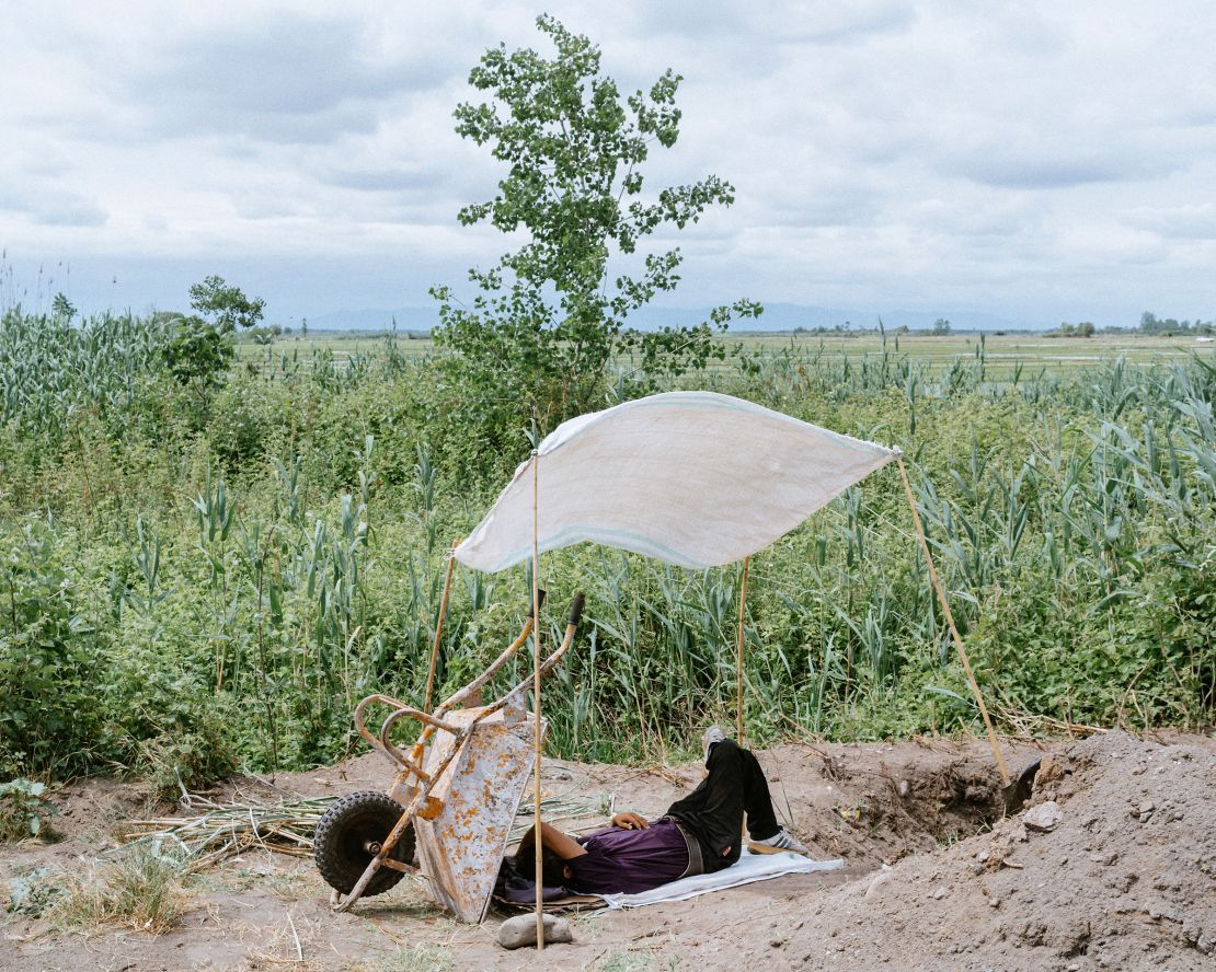 May 2020: A farmer rests while water is pumping from the lagoon to his farm. Extracting water directly from the lagoon has no regulation. 